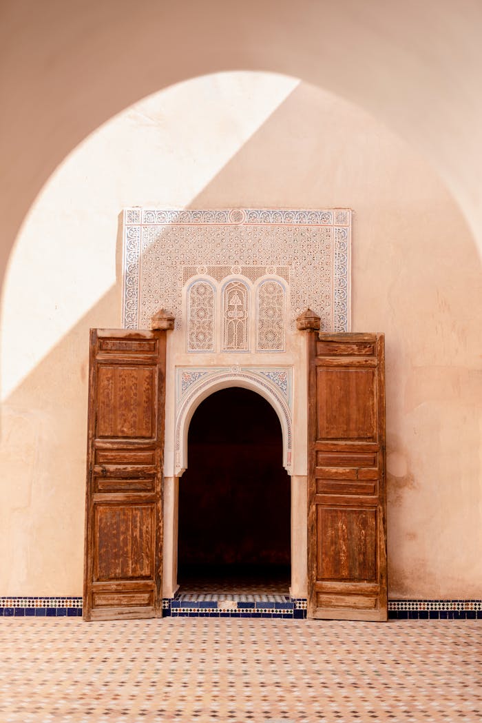 embark Beautiful Moroccan architecture featuring a wooden door and ornate archway in Marrakech, Morocco.